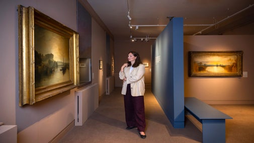 Curator Emily Knight views one of the paintings in the Turner exhibition